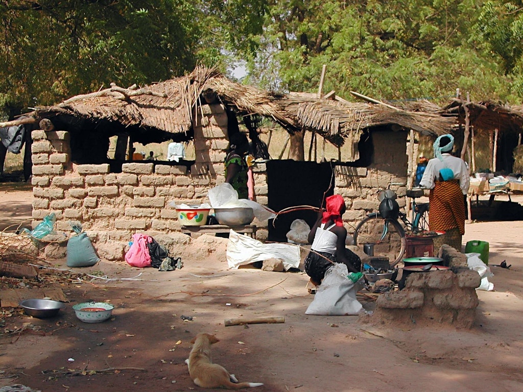 Two women in front of a house in Burkina Faso